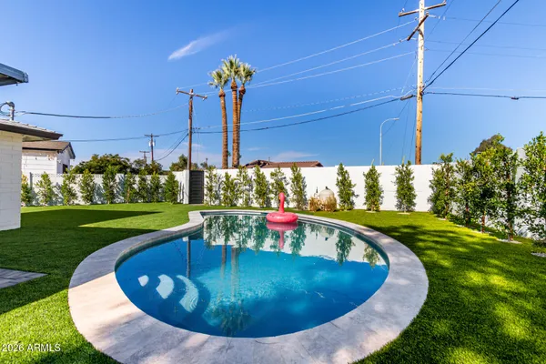 a view of a swimming pool with a yard