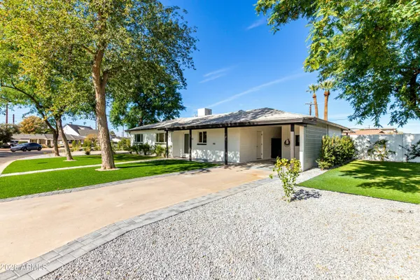 a front view of a house with a yard and porch