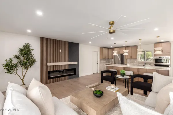 a living room with furniture and kitchen view