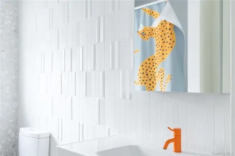 a bathroom with a window and a shower curtain