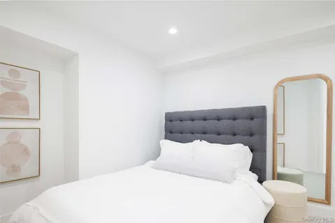 a bedroom with a bed and a mirror