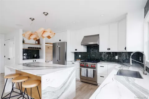a kitchen with stainless steel appliances kitchen island granite countertop a sink and cabinets