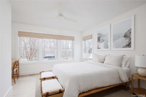 a bedroom with a bed and a large window