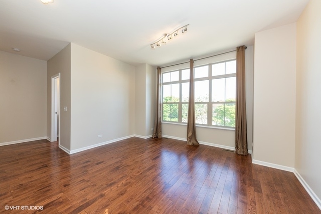 323 Aspen Pointe Road Vernon Hills, IL 60061 - Photo 3 of 12 a view of an empty room with wooden floor and a window