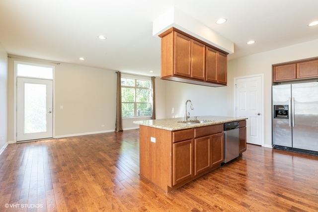 323 Aspen Pointe Road Vernon Hills, IL 60061 - Photo 4 of 12 a large kitchen with stainless steel appliances granite countertop a stove and a sink