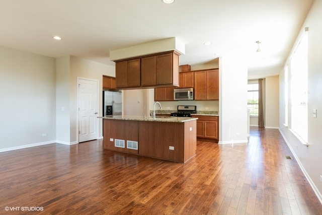 323 Aspen Pointe Road Vernon Hills, IL 60061 - Photo 5 of 12 a kitchen with a refrigerator and a stove top oven