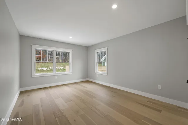 a bathroom with a double vanity sink toilet mirror and bathtub