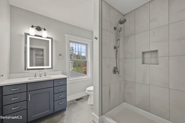 a bedroom with a large bed couch and a window