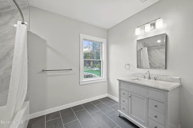 a view of backyard with large window and a potted plant