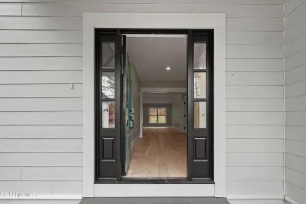 a view of a porch with a floor to ceiling window and outside area