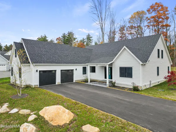 a bedroom with a bed couch and a window