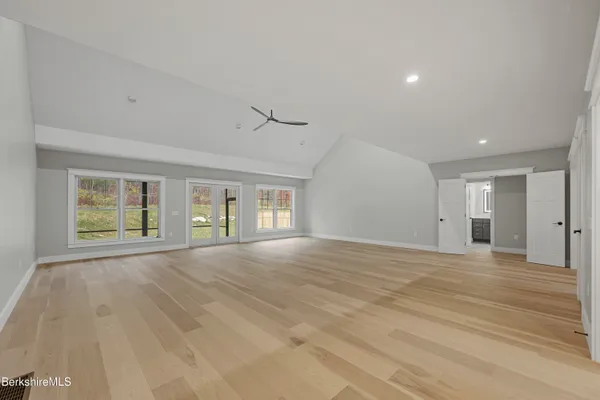 a kitchen with stainless steel appliances a dining table chairs stove and refrigerator