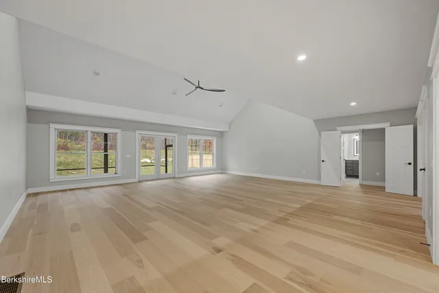 a kitchen with stainless steel appliances a dining table chairs stove and refrigerator