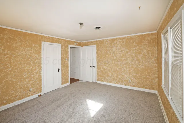 an empty room with a empty space and windows