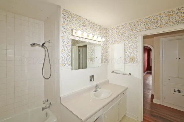 a bathroom with a tub and shower