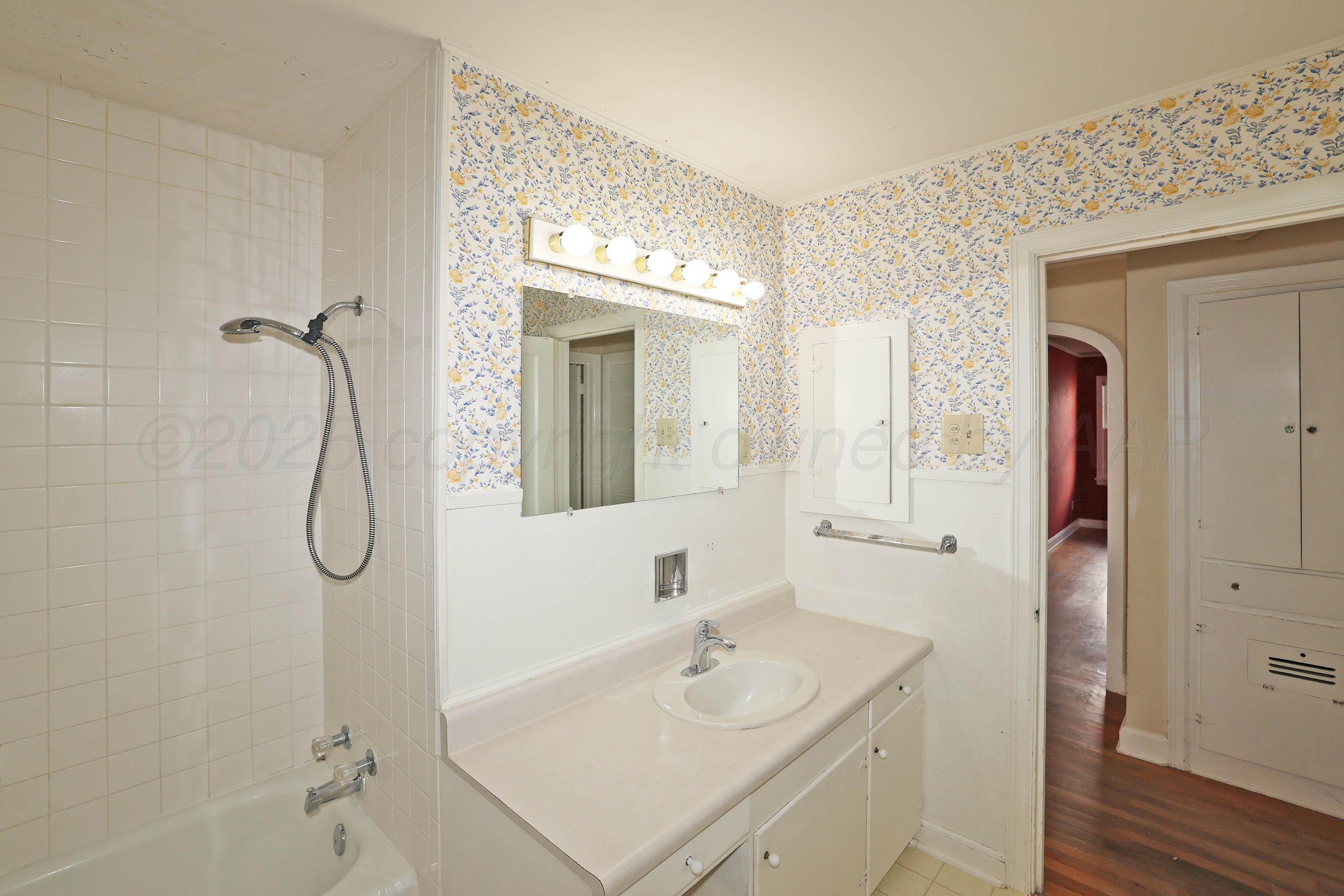 1528 South Lipscomb Street Amarillo, TX 79102 - Photo 23 of 24 a bathroom with a sink vanity mirror and shower