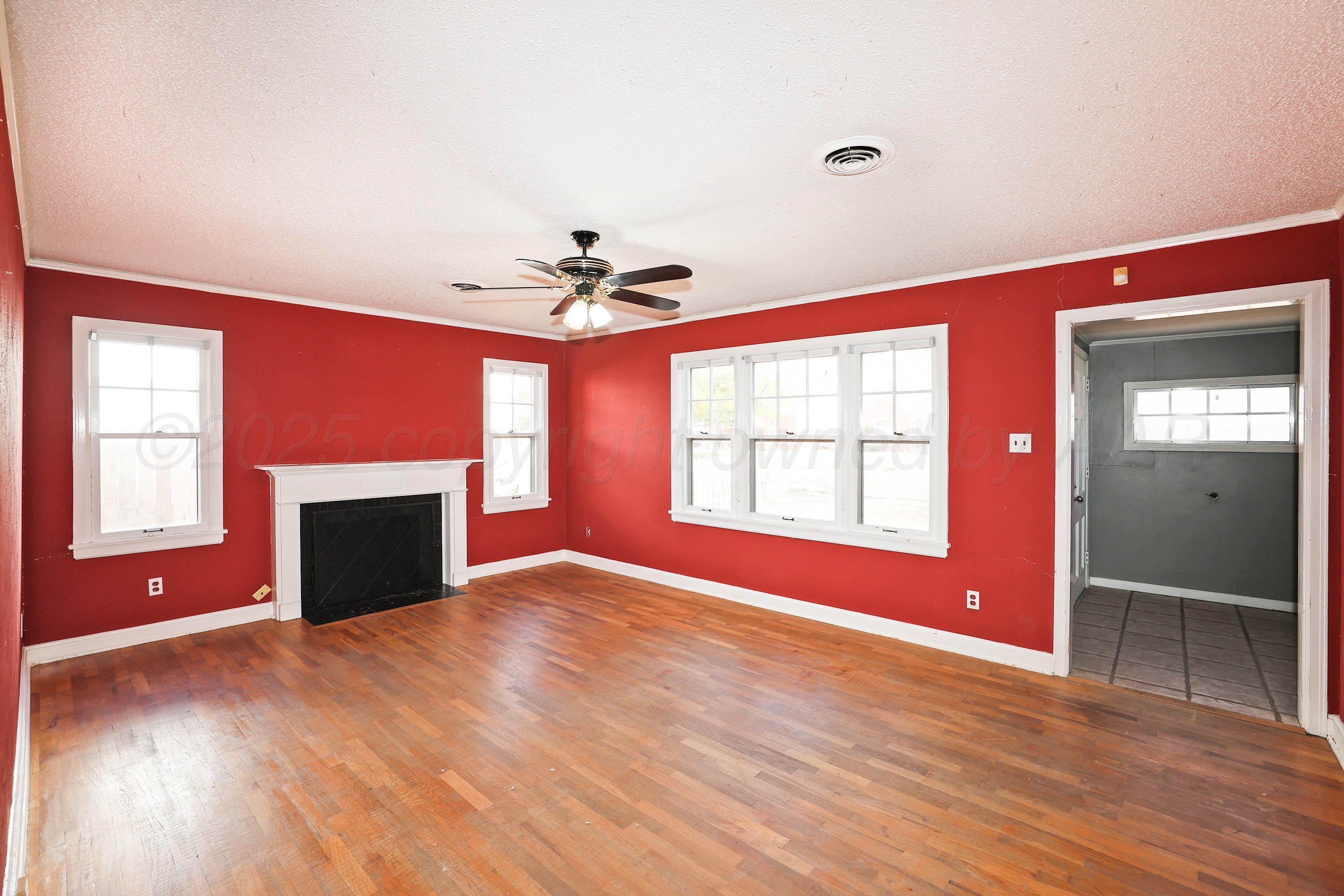 1528 South Lipscomb Street Amarillo, TX 79102 - Photo 8 of 24 a view of an empty room with a window and fireplace