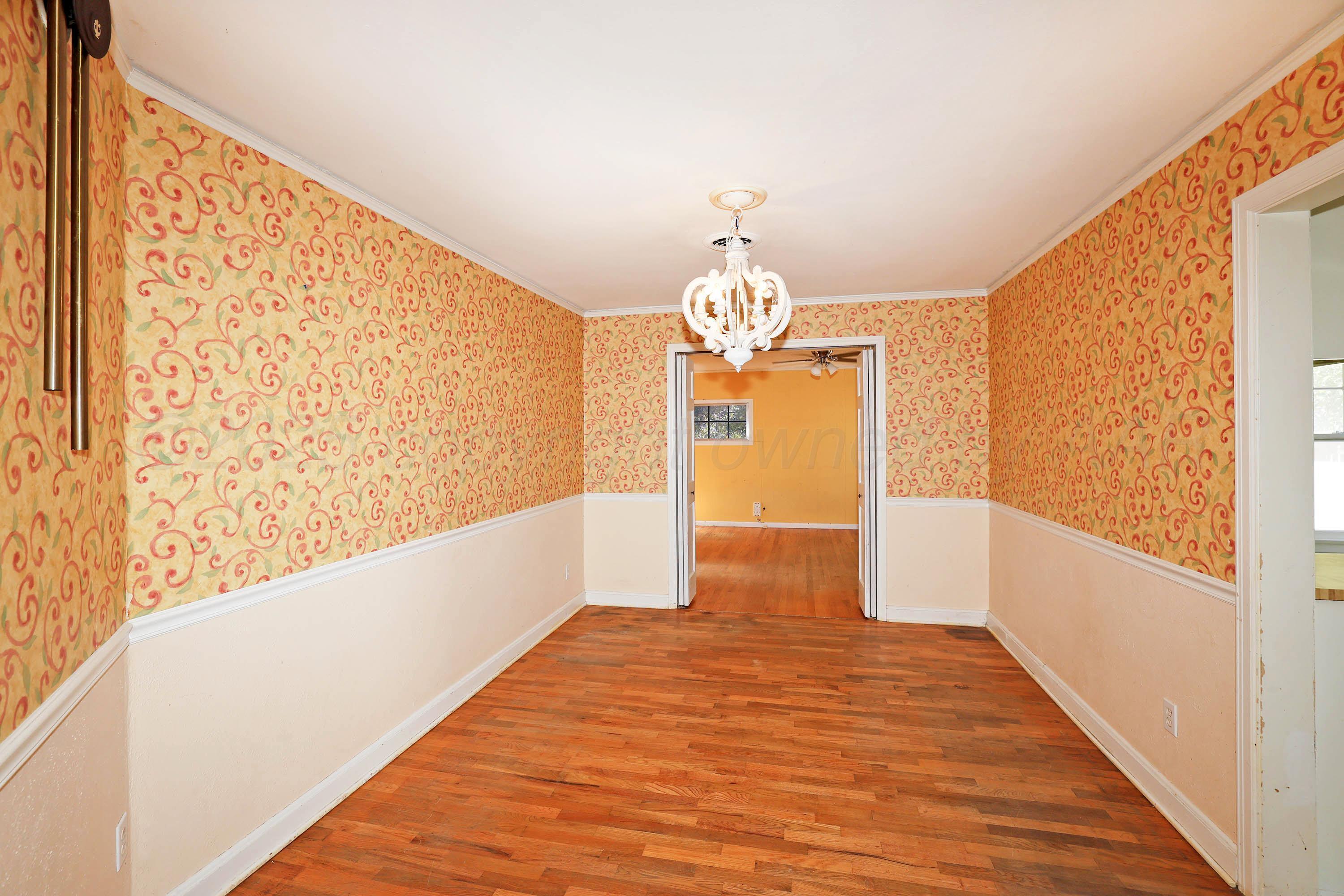 1528 South Lipscomb Street Amarillo, TX 79102 - Photo 10 of 24 a view of a big room with wooden floor and chandelier