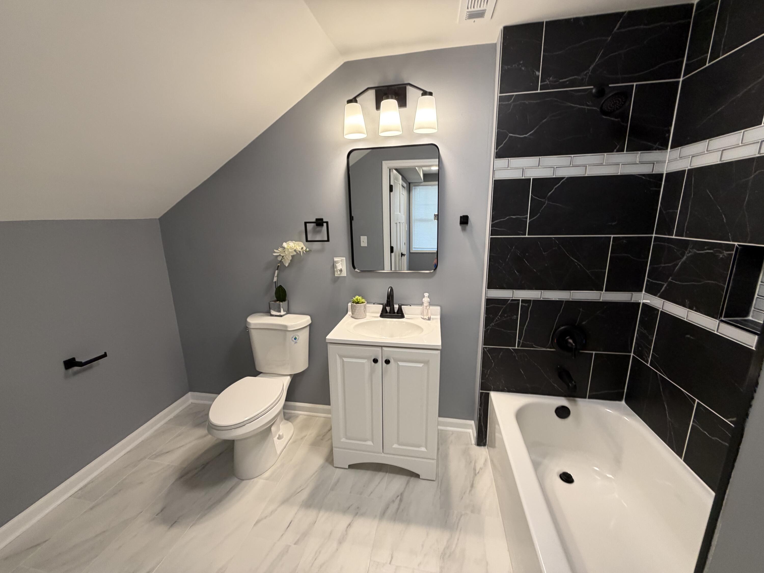 2425 Adams Street Gary, IN 46407 - Photo 22 of 26 a bathroom with a toilet a sink and mirror