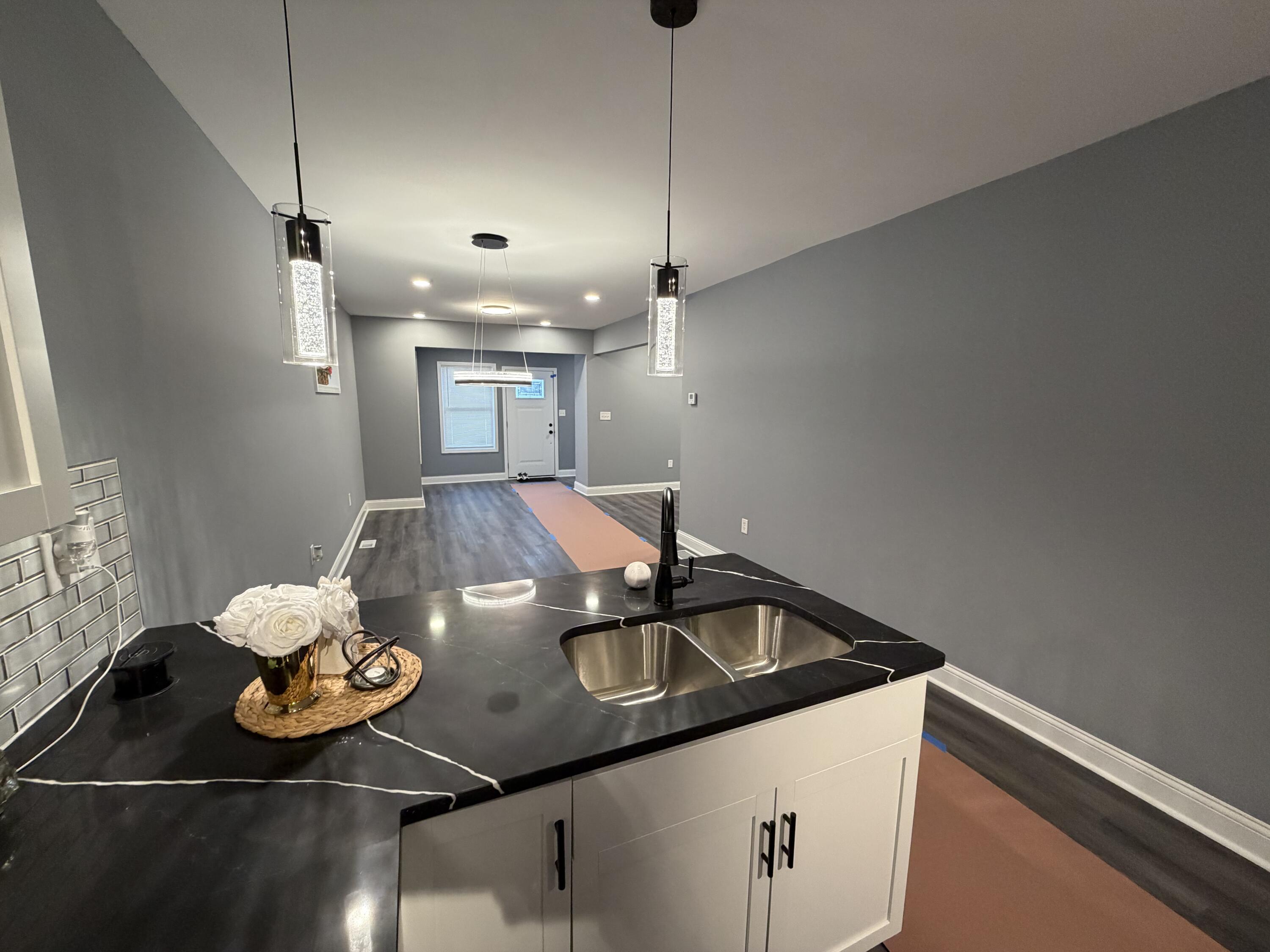 2425 Adams Street Gary, IN 46407 - Photo 7 of 26 a kitchen with a sink and chandelier