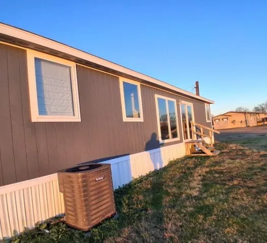 a backyard of a house with barbeque oven