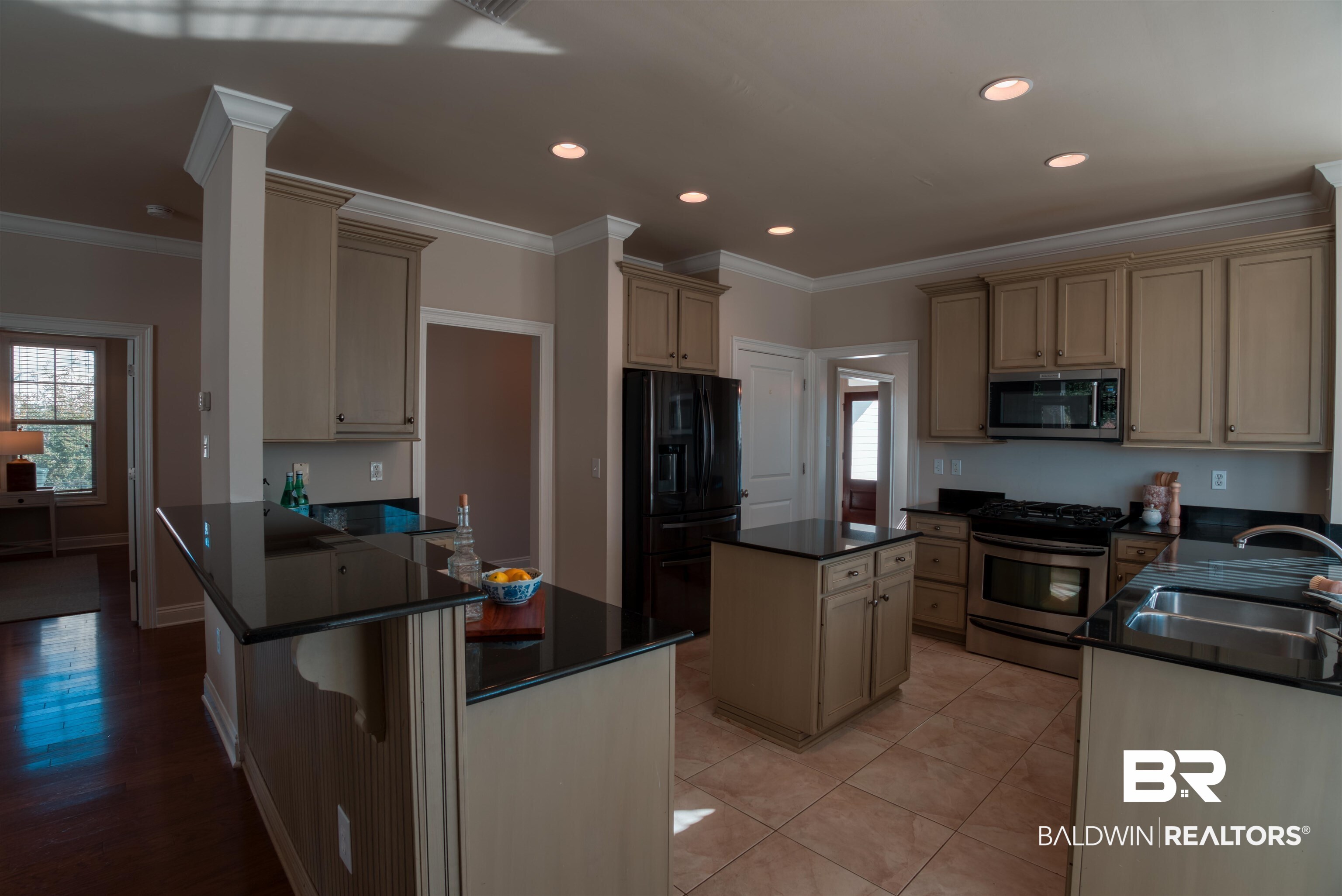 24561 Austin Road Daphne, AL 36526 - Photo 11 of 57 Kitchen featuring cream cabinets, sink, ornamental molding, a kitchen island, and stainless steel appliances