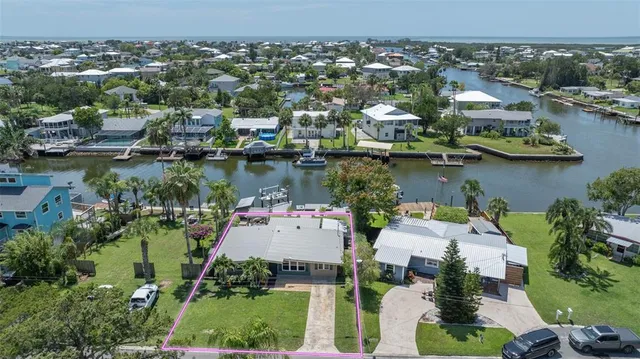 an aerial view of a house with a lake view
