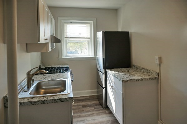 95 Adams Street, Unit 9 Waltham, MA 02453 - Photo 6 of 8 a kitchen with a stove and a refrigerator