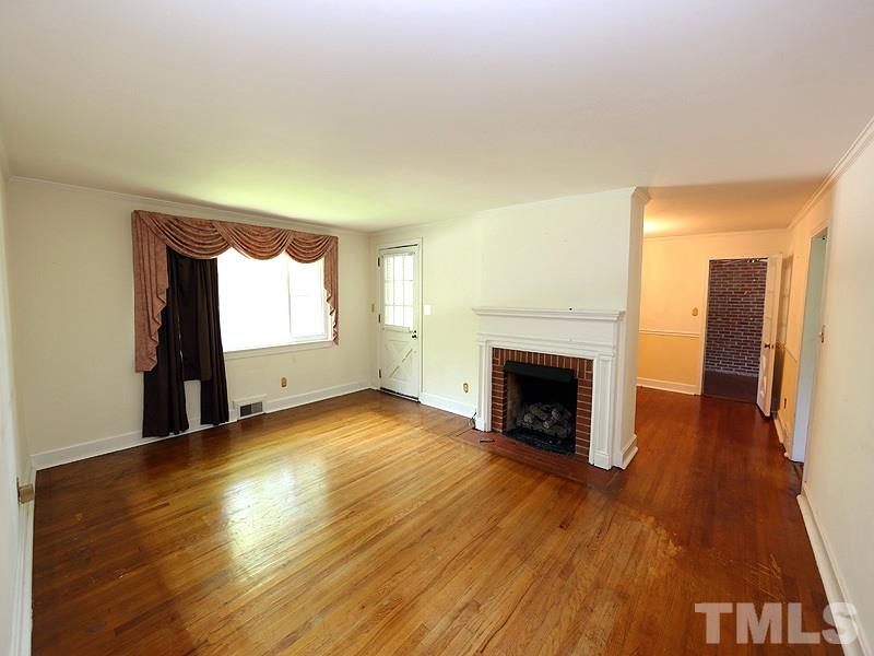 103 Forest Road Oxford, NC 27565 - Photo 2 of 20 a view of a livingroom with wooden floor and a fireplace