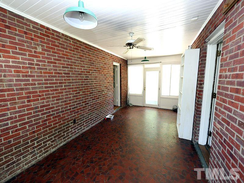 103 Forest Road Oxford, NC 27565 - Photo 11 of 20 a view of a hallway with wooden floor and a chandelier