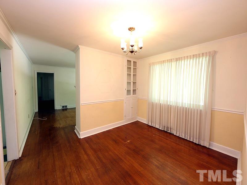 103 Forest Road Oxford, NC 27565 - Photo 3 of 20 an empty room with wooden floor and windows