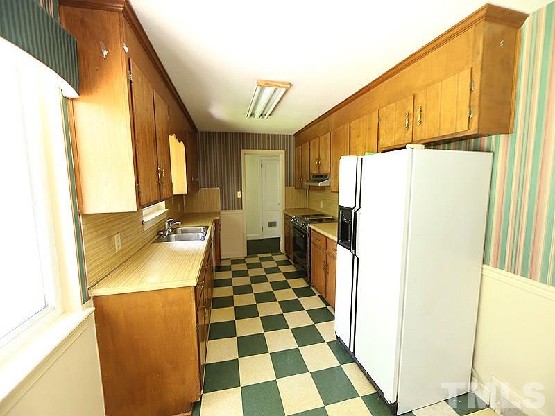 103 Forest Road Oxford, NC 27565 - Photo 5 of 20 a kitchen with a refrigerator a sink and a window