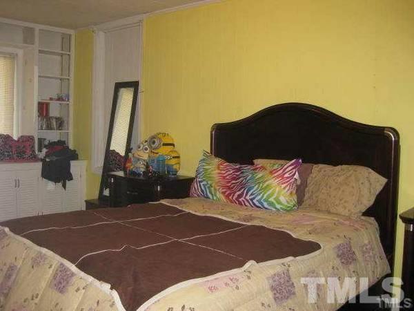 103 Forest Road Oxford, NC 27565 - Photo 7 of 20 a bedroom with a bed and a painting on the wall