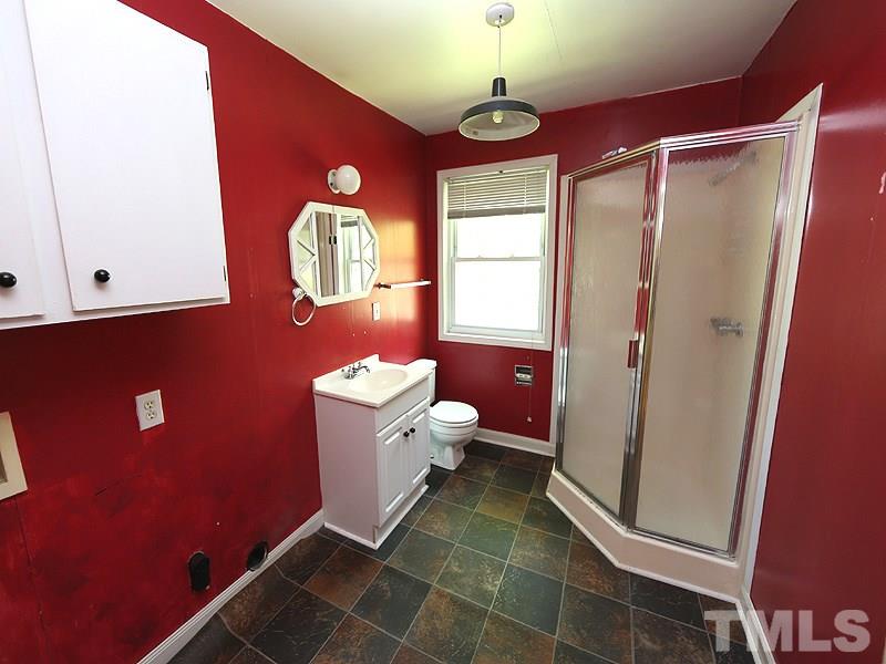 103 Forest Road Oxford, NC 27565 - Photo 8 of 20 a bathroom with a toilet sink and mirror