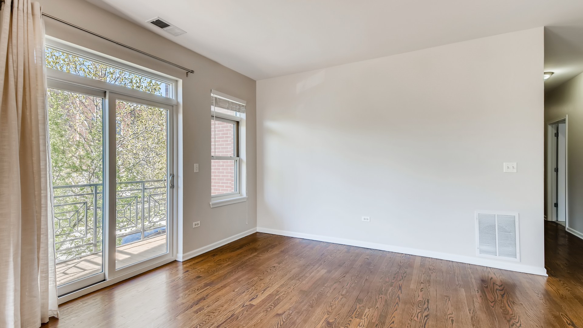 757 West 14th Place, Unit 2B Chicago, IL 60607 - Photo 11 of 32 a view of an empty room with wooden floor and a window
