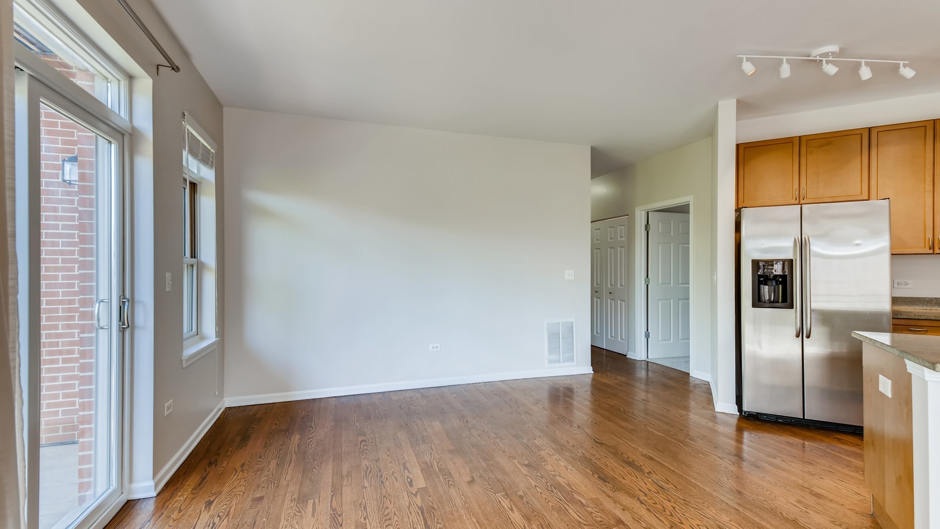 757 West 14th Place, Unit 2B Chicago, IL 60607 - Photo 12 of 32 a view of a kitchen with a fridge and wooden floor