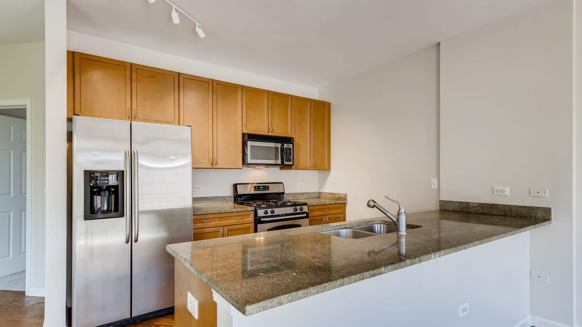 757 West 14th Place, Unit 2B Chicago, IL 60607 - Photo 14 of 32 a kitchen with stainless steel appliances granite countertop a sink a stove and a refrigerator