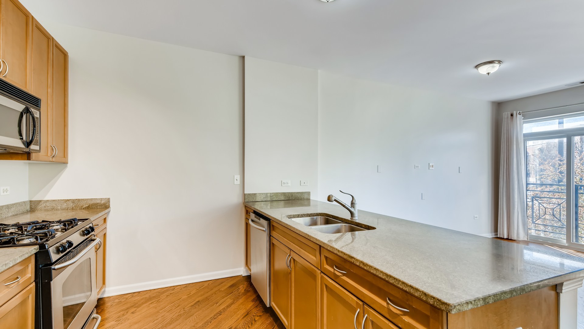 757 West 14th Place, Unit 2B Chicago, IL 60607 - Photo 17 of 32 a kitchen that has a sink and a stove