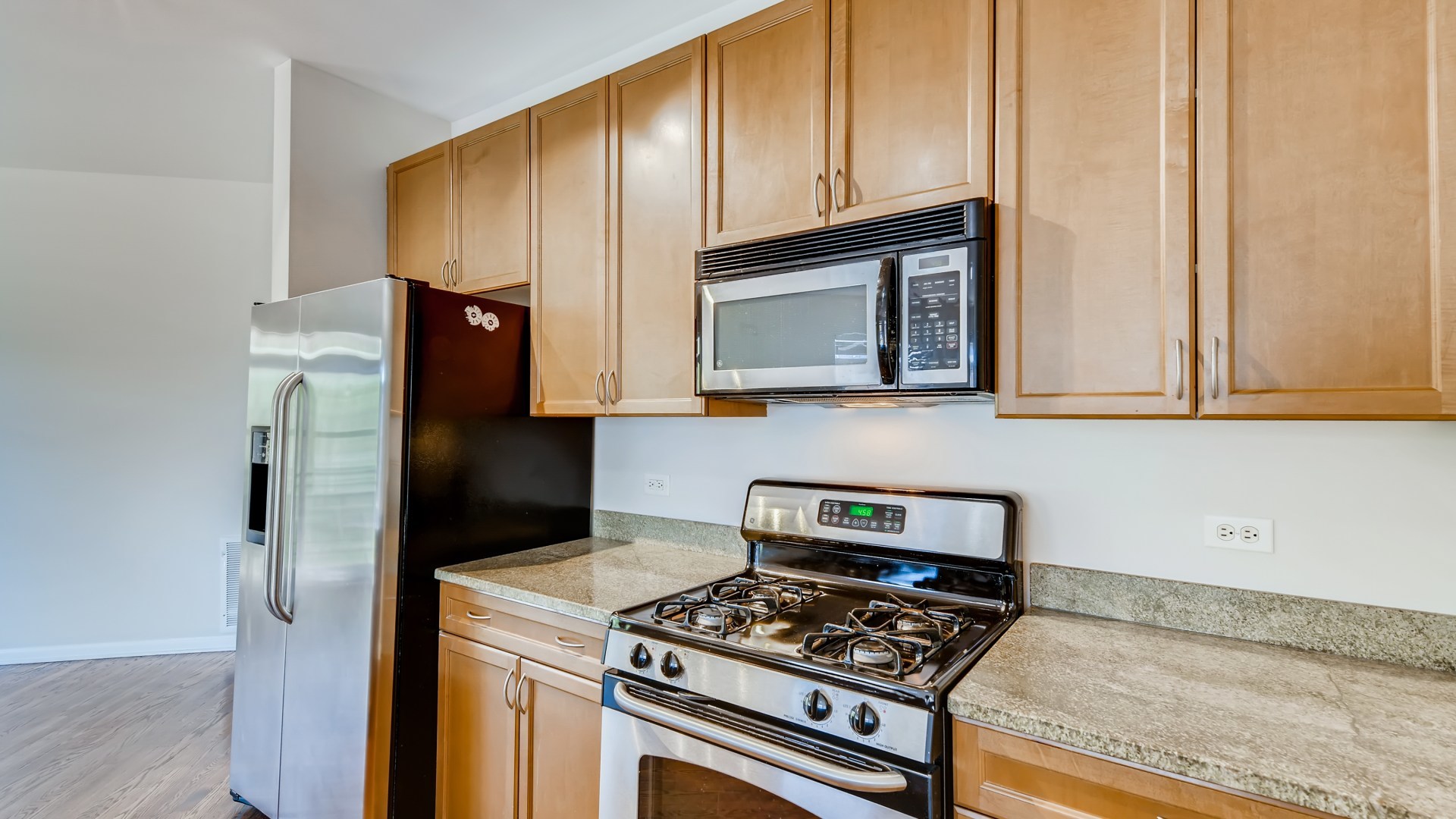 757 West 14th Place, Unit 2B Chicago, IL 60607 - Photo 18 of 32 a kitchen with stainless steel appliances granite countertop a stove a refrigerator and a microwave