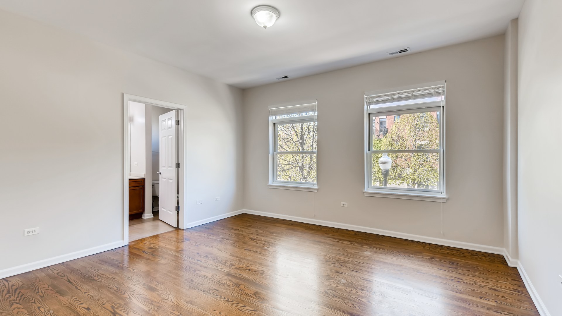 757 West 14th Place, Unit 2B Chicago, IL 60607 - Photo 19 of 32 a view of an empty room with wooden floor and a window