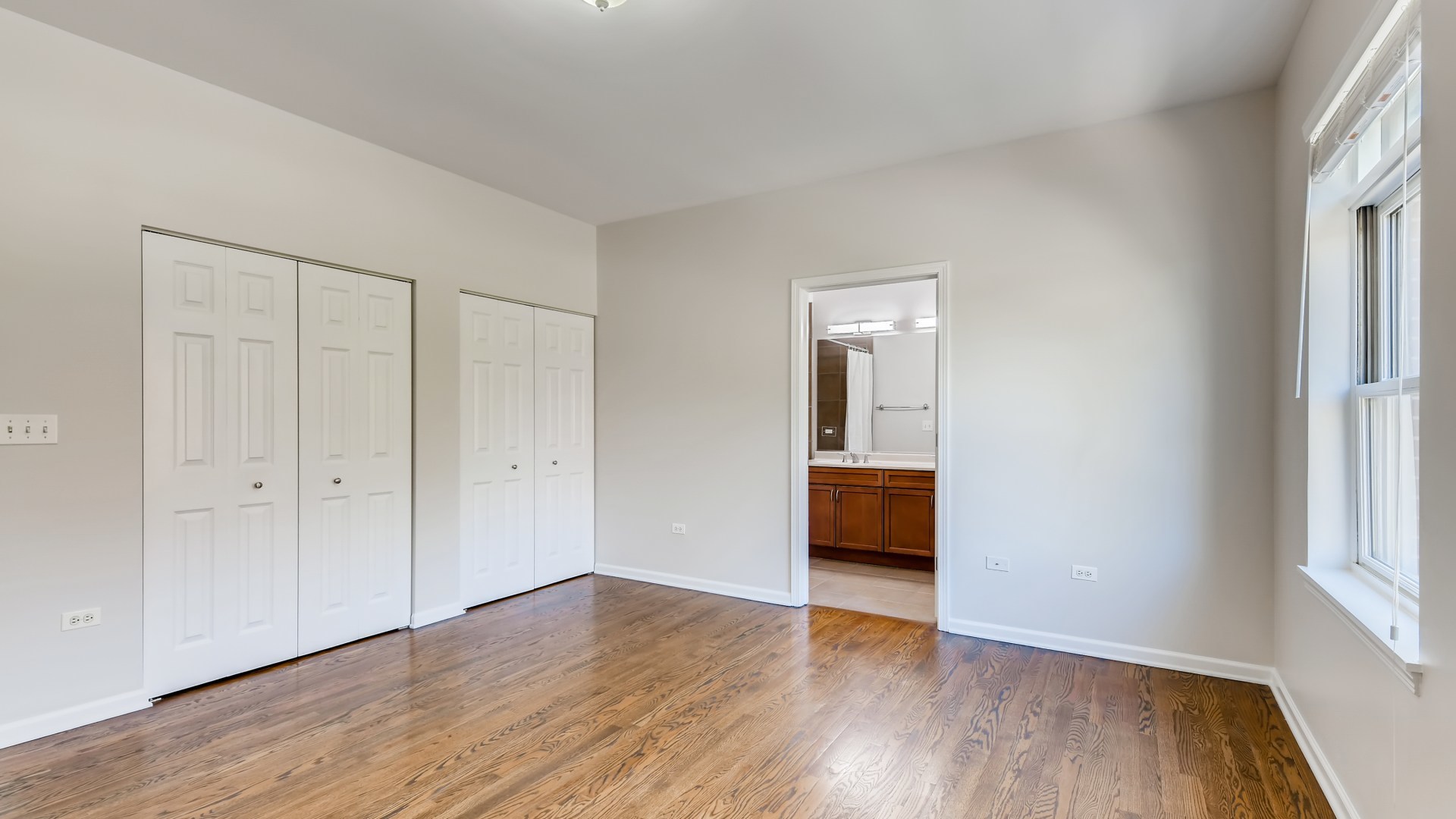 757 West 14th Place, Unit 2B Chicago, IL 60607 - Photo 20 of 32 a view of an empty room with wooden floor and a window