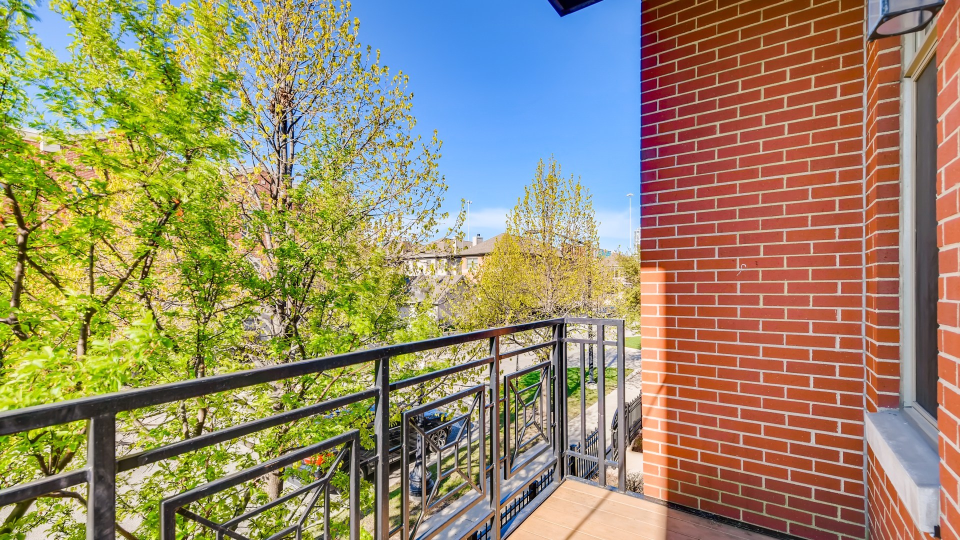 757 West 14th Place, Unit 2B Chicago, IL 60607 - Photo 30 of 32 a view of a balcony with wooden floor and fence