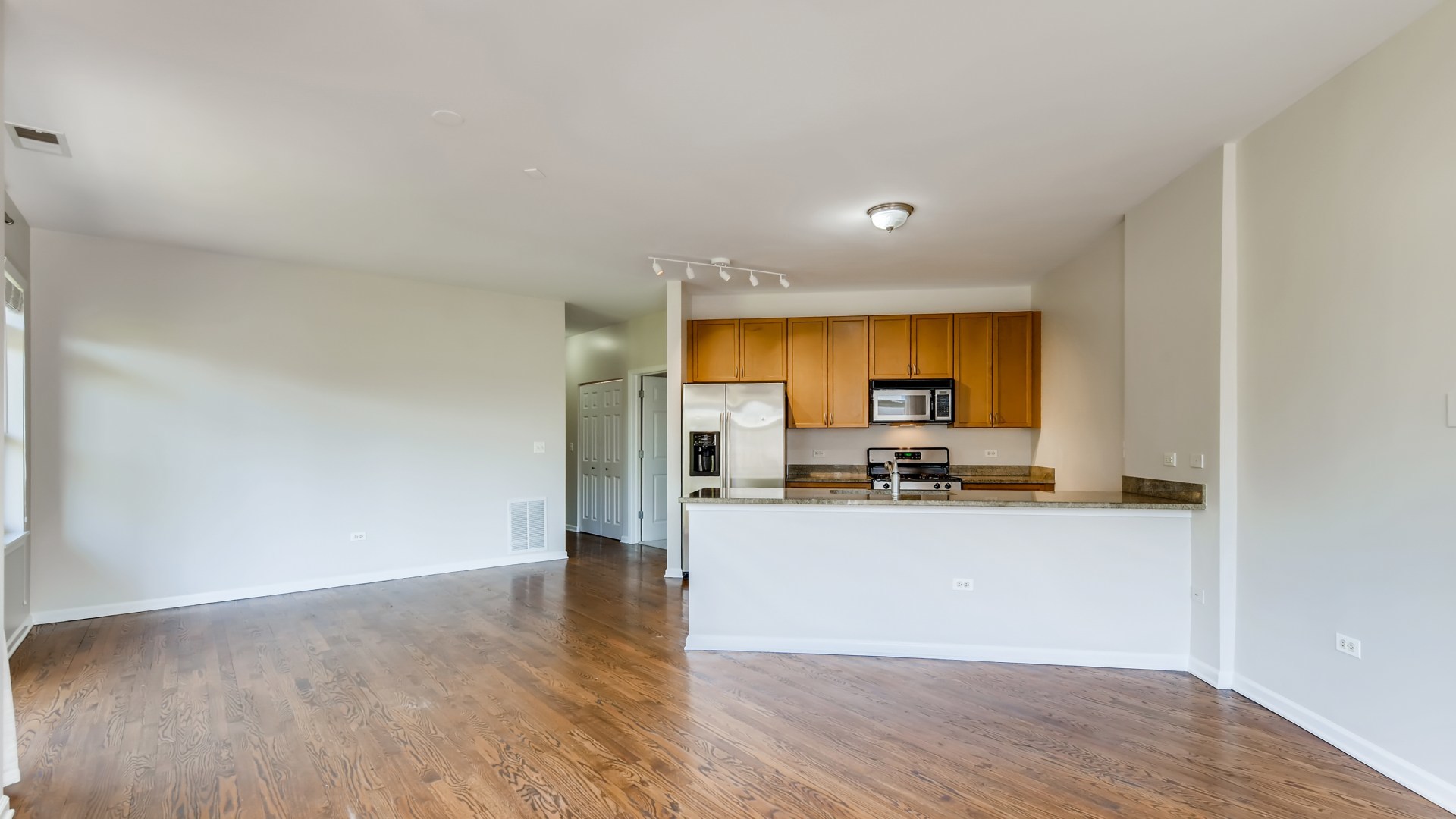 757 West 14th Place, Unit 2B Chicago, IL 60607 - Photo 8 of 32 a view of a kitchen with wooden floor