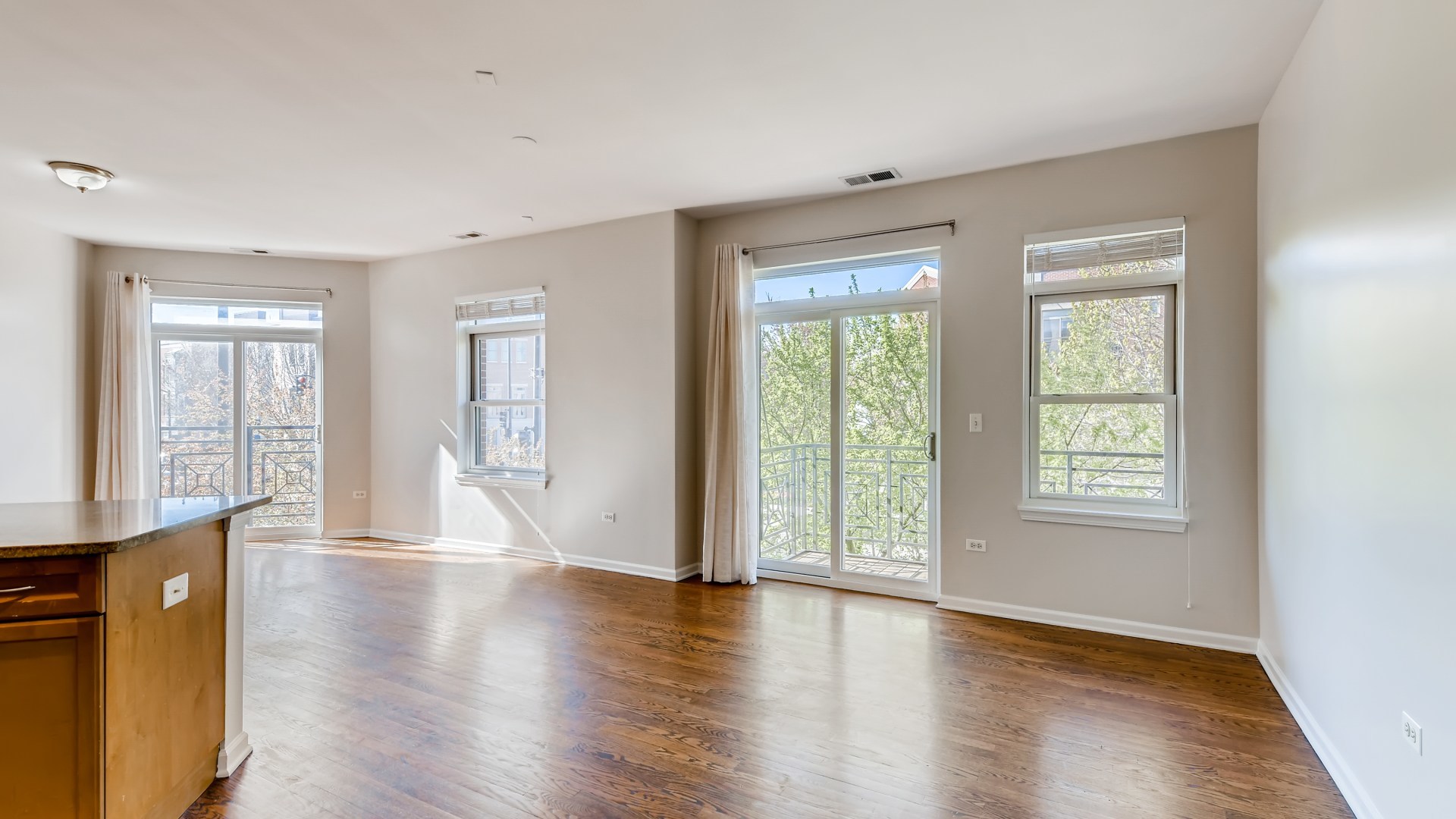 757 West 14th Place, Unit 2B Chicago, IL 60607 - Photo 10 of 32 a view of an empty room with wooden floor and a window