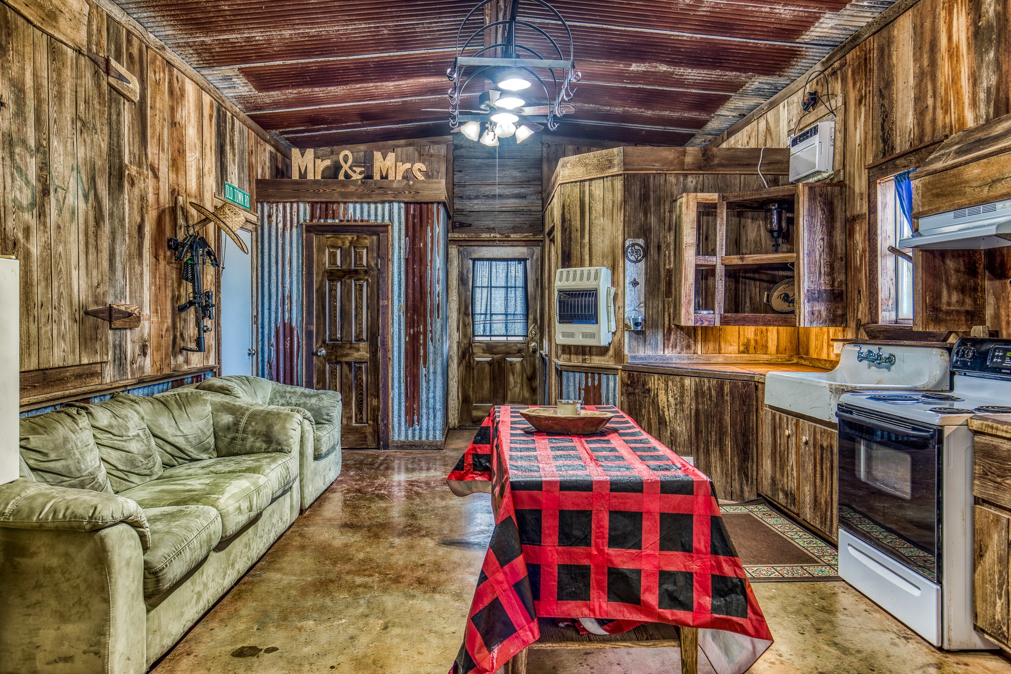 7300 Goehring Road Ledbetter, TX 78946 - Photo 7 of 21 a bedroom with furniture and a chandelier