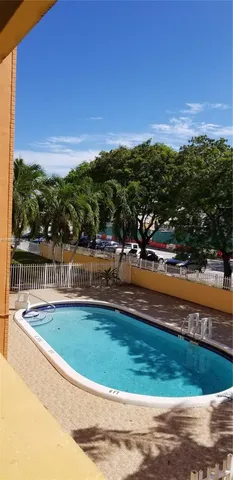 a view of swimming pool with outdoor seating and yard in back