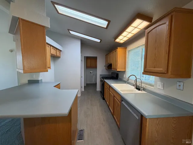 a kitchen with a sink a counter top space and cabinets