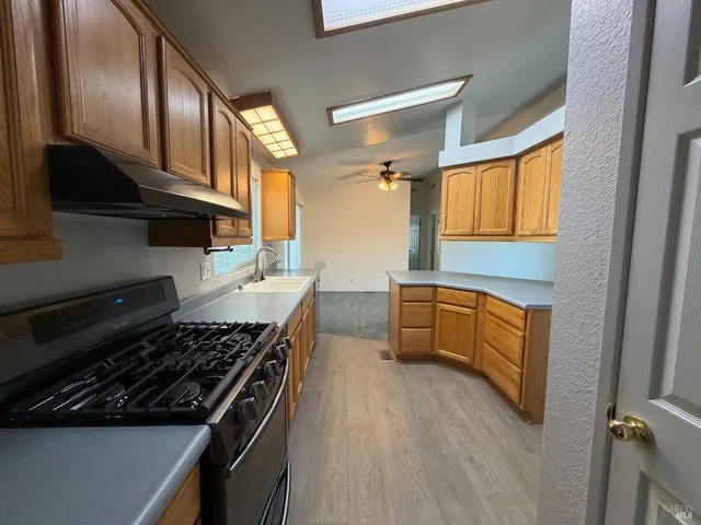 a kitchen with a stove a sink and a refrigerator
