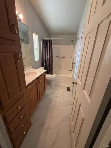 a bathroom with sink a mirror a vanity and a shower