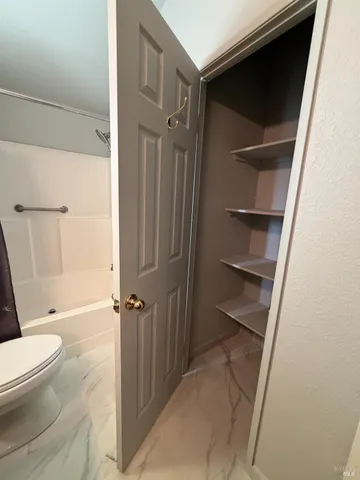 a bathroom with a toilet and a shower